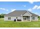 Rear exterior of home with a patio and a well-maintained lawn, perfect for outdoor enjoyment at 210 Dorothy Dr, China Grove, NC 28023
