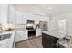 Modern kitchen with stainless steel appliances and granite countertops open to living space at 210 Dorothy Dr, China Grove, NC 28023