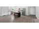 Bright kitchen with stainless steel appliances and an island with barstool seating at 210 Dorothy Dr, China Grove, NC 28023