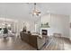 Open living room with fireplace, vaulted ceilings, wood floors, and views of the dining area at 210 Dorothy Dr, China Grove, NC 28023