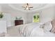 A bright main bedroom featuring neutral walls, plush carpeting, and a large window at 210 Dorothy Dr, China Grove, NC 28023