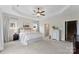 Spacious main bedroom with tray ceiling, carpet, and ample natural light at 210 Dorothy Dr, China Grove, NC 28023