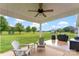 Relaxing covered patio with comfortable seating and an inviting view of the expansive backyard at 210 Dorothy Dr, China Grove, NC 28023