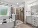 Elegant bathroom featuring a soaking tub, glass-enclosed shower, and dual vanity with ample counter space at 234 Ascot Run Way, Fort Mill, SC 29715