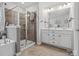 Well-lit bathroom with tub, glass-enclosed shower, double vanity with white cabinets offering plenty of storage at 234 Ascot Run Way, Fort Mill, SC 29715