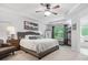 Spacious primary bedroom featuring a trey ceiling, a ceiling fan, and a view to the outside at 234 Ascot Run Way, Fort Mill, SC 29715