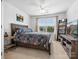 Bright bedroom with a queen bed, TV, ceiling fan, and large window with neighborhood views at 234 Ascot Run Way, Fort Mill, SC 29715