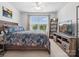 Inviting bedroom with a queen-sized bed, ceiling fan, and media center under the TV at 234 Ascot Run Way, Fort Mill, SC 29715