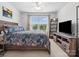Inviting bedroom with a queen-sized bed, ceiling fan, and media center under the TV at 234 Ascot Run Way, Fort Mill, SC 29715