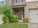 Charming front porch with brick accents, a cozy bench, and inviting curb appeal with manicured landscaping at 234 Ascot Run Way, Fort Mill, SC 29715
