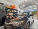 Spacious garage featuring a parked car, overhead storage, and an open door showcasing natural light at 234 Ascot Run Way, Fort Mill, SC 29715