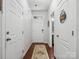 Hallway with wood floors, featuring a view of the entrance and a convenient half bathroom at 234 Ascot Run Way, Fort Mill, SC 29715
