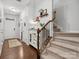 Hallway featuring stairs and a decorative cabinet with glass doors, creating a welcoming space at 234 Ascot Run Way, Fort Mill, SC 29715