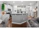 Open-concept kitchen with white cabinetry, stainless steel appliances, and a convenient breakfast bar at 234 Ascot Run Way, Fort Mill, SC 29715
