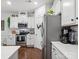 Modern kitchen with white cabinets, stainless steel appliances, and hardwood flooring at 234 Ascot Run Way, Fort Mill, SC 29715