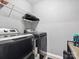 Functional laundry room featuring modern, front-loading washer and dryer, and wire shelving at 234 Ascot Run Way, Fort Mill, SC 29715