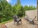 Stone patio with outdoor seating, offering a peaceful spot for relaxation and enjoying the natural surroundings at 234 Ascot Run Way, Fort Mill, SC 29715