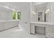Bright bathroom with dual sinks, a large mirror, tub and vanity with make up mirror at 2710 Briarcliff Pl, Charlotte, NC 28207