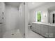 Elegant bathroom featuring a glass enclosed shower and a vanity with marble countertop at 2710 Briarcliff Pl, Charlotte, NC 28207