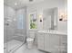 Modern bathroom featuring a glass enclosed shower and a sleek vanity with marble countertop at 2710 Briarcliff Pl, Charlotte, NC 28207