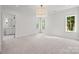 Bright bedroom featuring recessed lighting, a chandelier and a view of the outdoor scenery at 2710 Briarcliff Pl, Charlotte, NC 28207