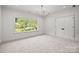Bright bedroom featuring a modern light fixture and a large window with outdoor views at 2710 Briarcliff Pl, Charlotte, NC 28207