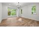 Bright bedroom with large windows, hardwood floors and modern lighting at 2710 Briarcliff Pl, Charlotte, NC 28207