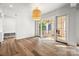 Bright dining room with hardwood floors, a stylish chandelier and sliding glass doors to a balcony at 2710 Briarcliff Pl, Charlotte, NC 28207