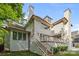 Lovely home exterior features brick and siding with outdoor stairs leading up at 2710 Briarcliff Pl, Charlotte, NC 28207