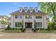 Stunning two-story home with white brick, gray roof, dormers, and beautifully landscaped front yard at 2710 Briarcliff Pl, Charlotte, NC 28207