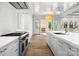 Spacious kitchen featuring stainless steel appliances, a large island with sink and seating, and hardwood floors at 2710 Briarcliff Pl, Charlotte, NC 28207