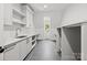 Well-lit laundry room with modern cabinetry and a sink, providing functionality and style at 2710 Briarcliff Pl, Charlotte, NC 28207