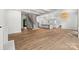 Open living area with hardwood floors, staircase, and a view of the kitchen with modern appliances at 2710 Briarcliff Pl, Charlotte, NC 28207