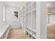 Well-organized mudroom with custom built-in shelving and bench, hardwood floors, and natural light at 2710 Briarcliff Pl, Charlotte, NC 28207
