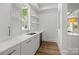Bright pantry with white countertops, cabinets, shelves, a beverage cooler and hardwood floors at 2710 Briarcliff Pl, Charlotte, NC 28207