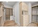 Walk-in closet with custom shelving, drawers, and hardwood floors at 2710 Briarcliff Pl, Charlotte, NC 28207