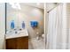 Cozy bathroom featuring a single sink vanity, a toilet, and a shower with a curtain at 286 Liverpool Rd, Rock Hill, SC 29730