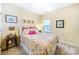 Charming bedroom with floral bedding, decorative pillows, framed artwork, and a window at 286 Liverpool Rd, Rock Hill, SC 29730