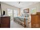 Cozy bedroom with a wrought iron bed frame, dresser, and a window that provides natural light at 286 Liverpool Rd, Rock Hill, SC 29730