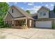 Charming brick home with a covered porch, two-car garage, mature trees, and a spacious driveway at 286 Liverpool Rd, Rock Hill, SC 29730