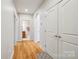 Hallway with wood floors and white doors, leading to an arched doorway with a glimpse of a bathroom at 286 Liverpool Rd, Rock Hill, SC 29730