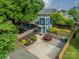 Overhead view of a blue two-story home featuring a yellow door, well landscaped yard, and a gravel parking area at 2915 Wesley Ave, Charlotte, NC 28205