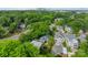 Aerial view of the neighborhood and home showcasing the lush greenery and the blue exterior at 2915 Wesley Ave, Charlotte, NC 28205