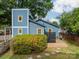 Charming backyard featuring a deck, blue exterior and mature trees, perfect for relaxation at 2915 Wesley Ave, Charlotte, NC 28205