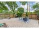 Relaxing backyard patio area with brick pavers, outdoor furniture, grill, and privacy fence at 2915 Wesley Ave, Charlotte, NC 28205