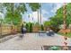 Relaxing backyard patio area with brick pavers, outdoor furniture, grill, privacy fence and string lights at 2915 Wesley Ave, Charlotte, NC 28205