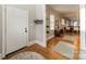 Inviting entryway with hardwood floors, neutral walls, a white front door and a view of the dining area at 2915 Wesley Ave, Charlotte, NC 28205