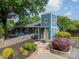 Two story home featuring a yellow door, beautiful landscaping and a lush green tree canopy on a partly cloudy day at 2915 Wesley Ave, Charlotte, NC 28205