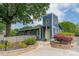 Charming blue two-story home featuring a yellow door, beautiful landscaping and a lush green tree canopy at 2915 Wesley Ave, Charlotte, NC 28205