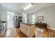Bright kitchen featuring a center island, stainless steel appliances, and gleaming hardwood floors at 2915 Wesley Ave, Charlotte, NC 28205